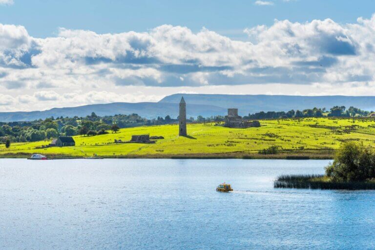 a round tower in the distance 30 ways to save on your trip to Ireland