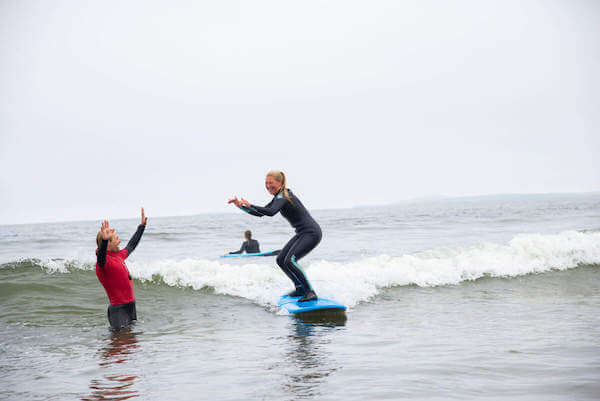 a woman on a surf board in the water unique things to do in Ireland