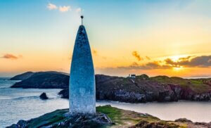 a large monument near the ocean County Cork