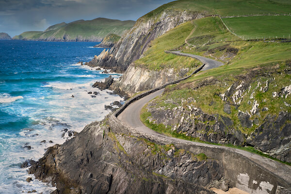 a curvy road along the coast day and road trips