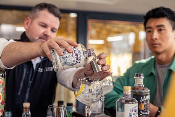 a man pouring whiskey into a glass Northern Ireland Spirits Trail