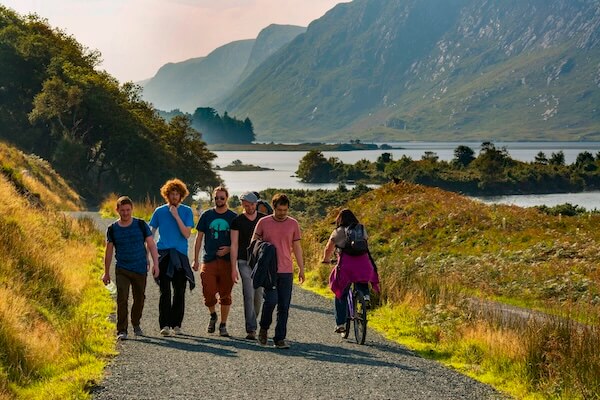 people walking on a path near a lake visiting Ireland's national parks
