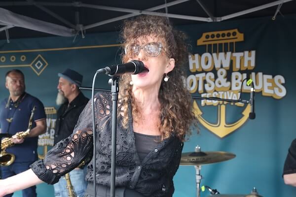 a woman singing into a microphone howth-roots-and-blues-festival