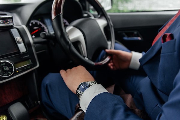 a driver at a steering wheel Ireland Vacations bespoke travel