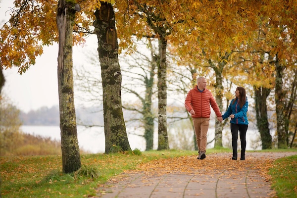 two people walking in the woods October in Ireland