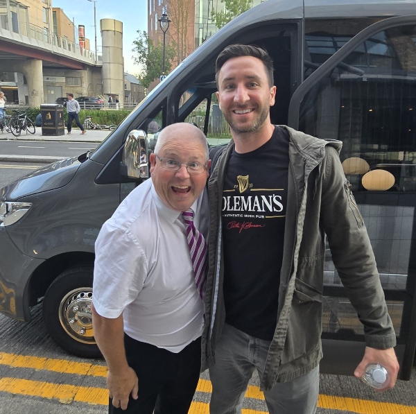 two men standing in front of a van Ireland My Way Tour Company