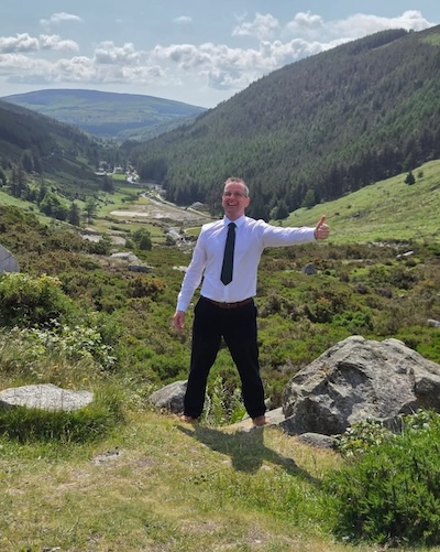a man giving a thumbs up with a valley behind him Dingle native and tour guide