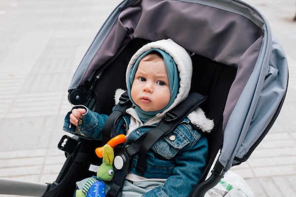 a child in a stroller traveling to Ireland with young children