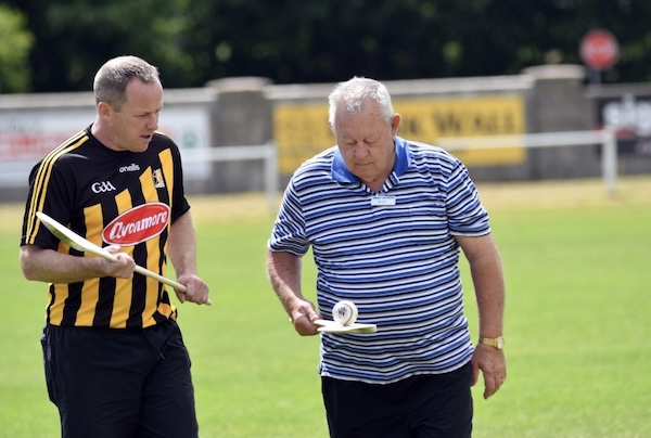 two men holding wooden sticks Hurling Tours Ireland