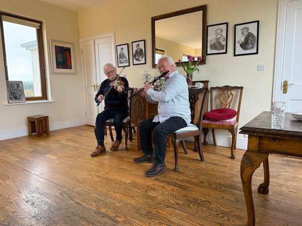 two men playing music in a house connect the dots tours